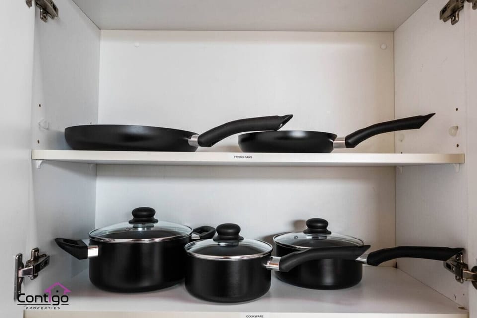 Fully equipped with pots, pans, and lids for all your cooking needs.