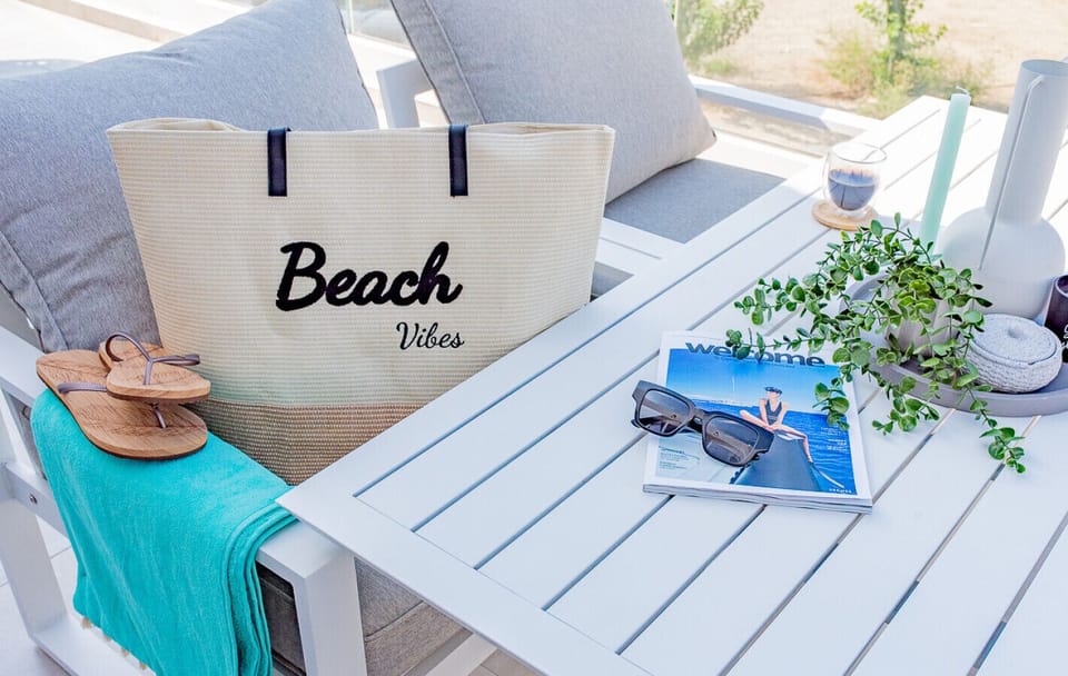 Bag packed with towels and beach toys — just grab and go!