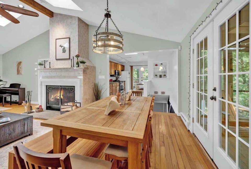 Elegant dining meets glowing hearth and open kitchen.
