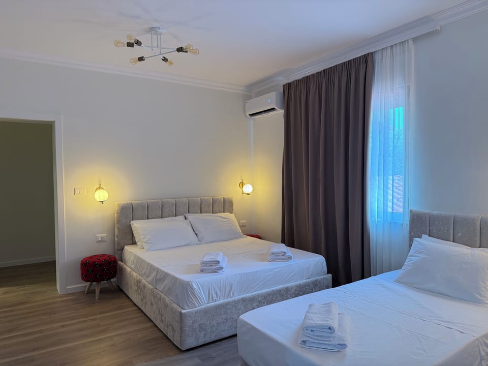 Standard Quadruple Room, City View | Desk, laptop workspace, blackout drapes, iron/ironing board