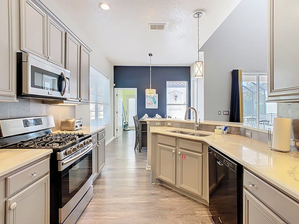 Modern kitchen cabinets and appliances. Solid counter tops, wood flooring