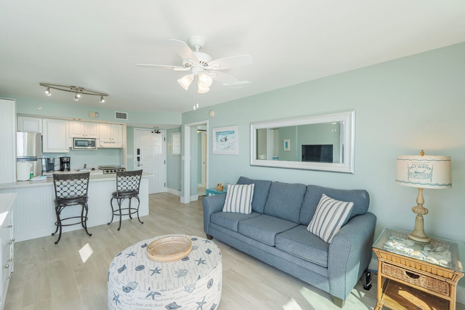 Coastal décor adds charm to this open-concept space, complete with breakfast bar seating.