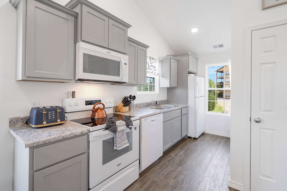 The open, airy kitchen offers ample space & every home comfort​