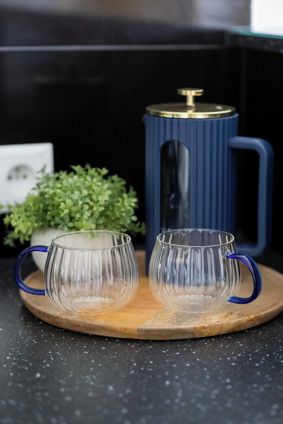 A set of colorful mugs neatly arranged on the kitchen countertop.