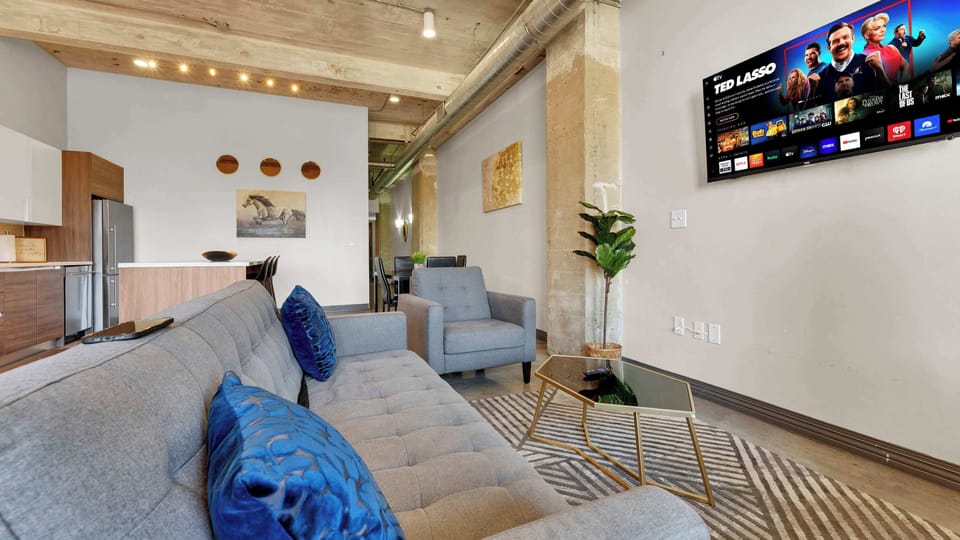 Living Room: Chic urban hideaway with stylish decor and a huge screen for movie nights!