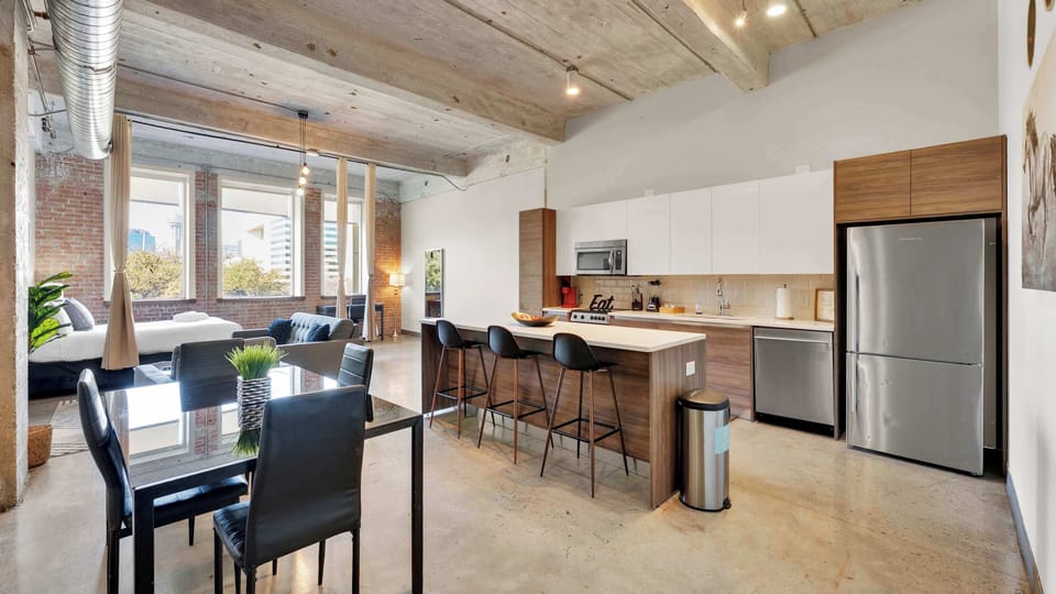 Kitchen: Sleek design with bar seating and skyline views = perfect for memorable meals!