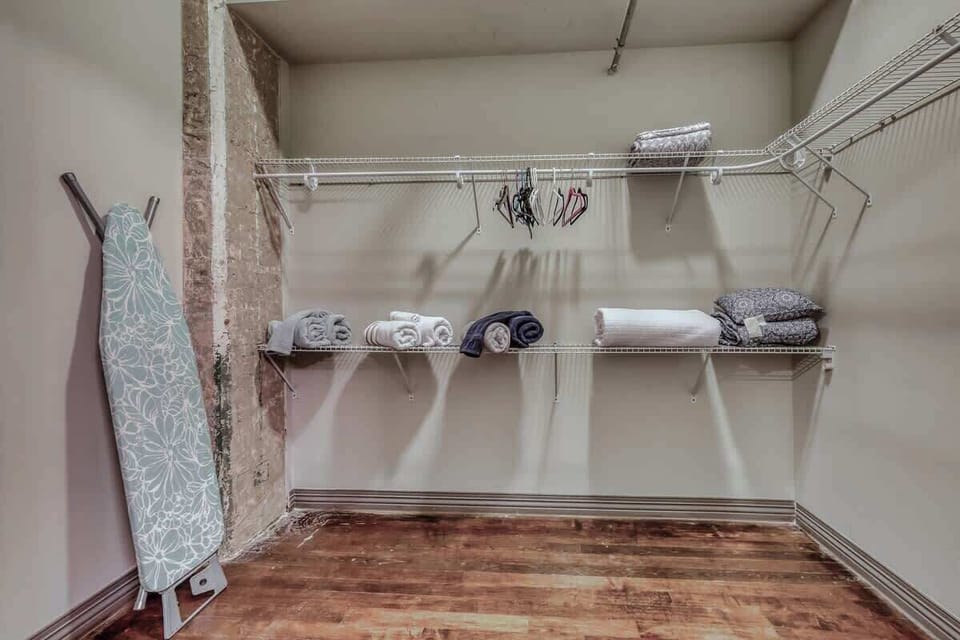Stay organized with ample shelves and ironing essentials at your fingertips!