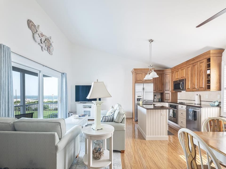 Inviting living space with an open layout connecting to the full kitchen and dining area.