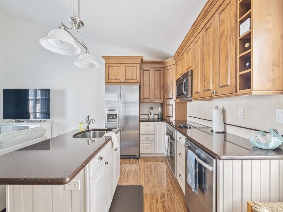 Well-equipped kitchen featuring stainless steel appliances and ample counter space.