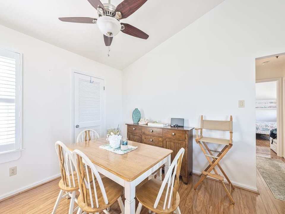 Casual dining space with natural wood tones and bright window light.
