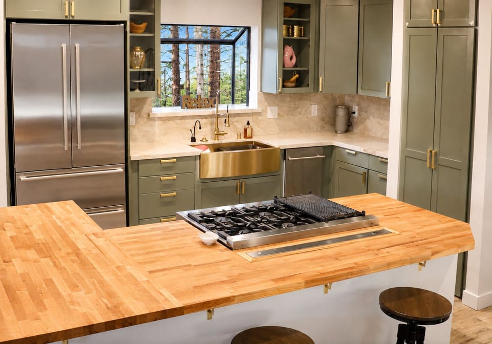 open plan chef's kitchen with view of the woods