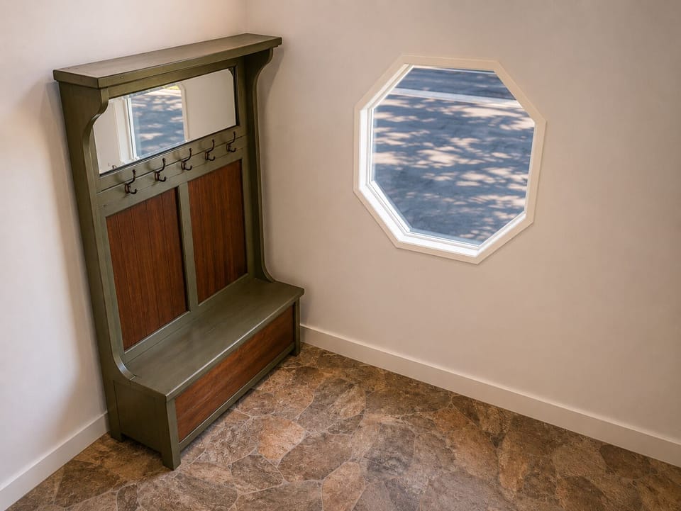The entryw includes stone flooring and storage bench and hooks for coats or bags