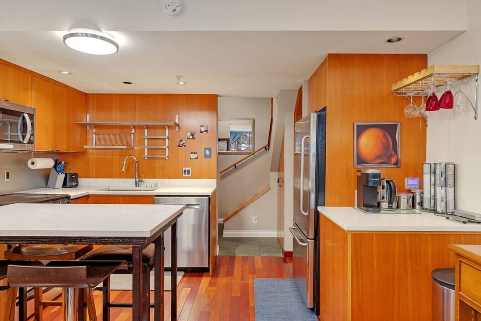Fully equipped kitchen with coffee maker, dishes, and cookware.