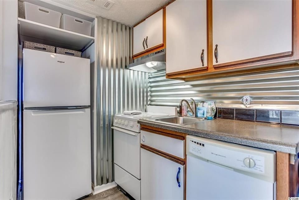 Bright kitchen with full-size appliances and overhead lighting