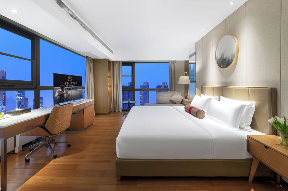 Premier Room, City View | Living area | TV, books, printers