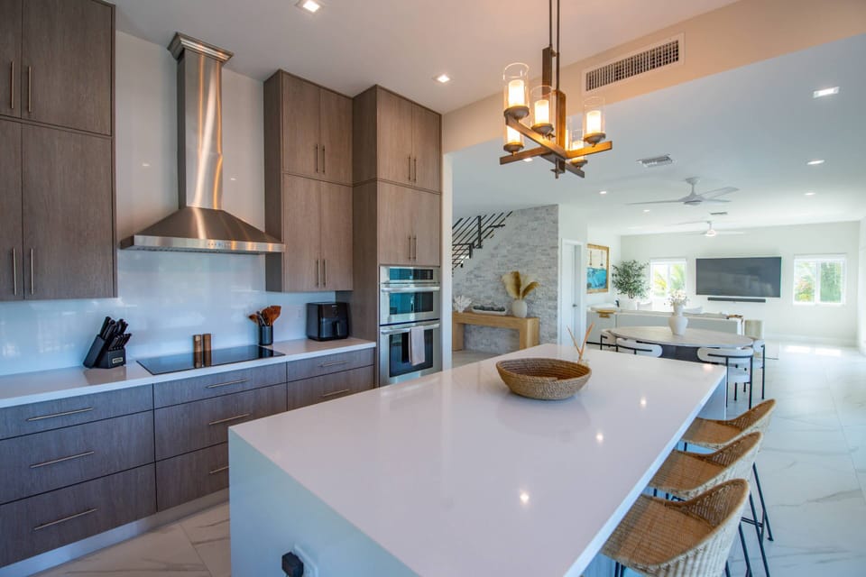 The open floor plan seamlessly connects the kitchen with the living room, creating a perfect space for cooking, dining, and relaxing together.