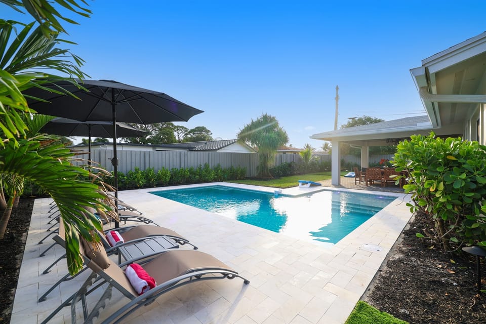 Start the day by the pool, with shaded loungers, tropical landscaping, and the covered patio close for easy meals and breaks.