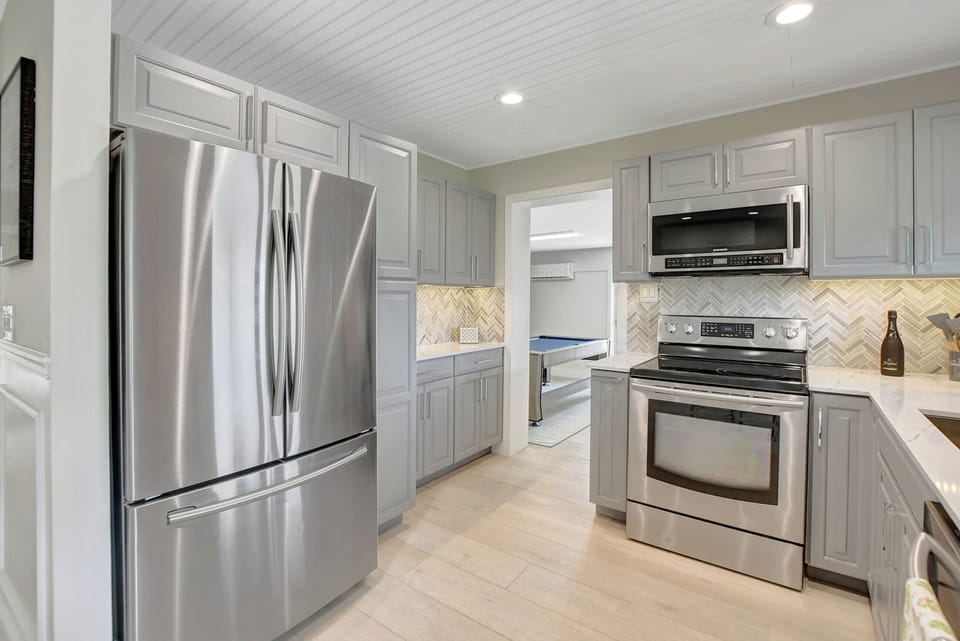 Step into our well-appointed kitchen, featuring a spacious fridge and all the amenities you need for a delightful cooking experience.