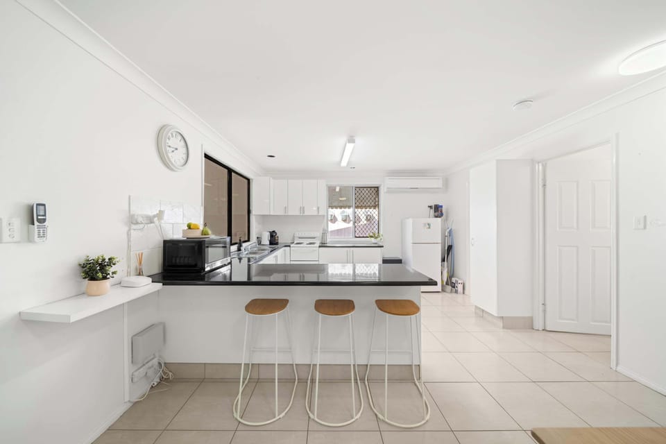 The fully equipped kitchen has everything needed for easy holiday dining, including an electric cooktop and oven, dishwasher, coffee machine, microwave, kettle and toaster. Whether you're preparing a quick breakfast or a family dinner, the generous l
