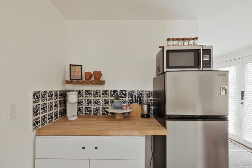 A bright and inviting kitchen space blending modern convenience with charming traditional tile accents, perfect for creating your own culinary adventures.