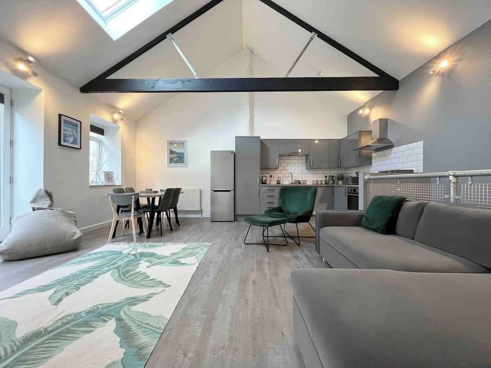 Open plan living room with kitchen and dining table.