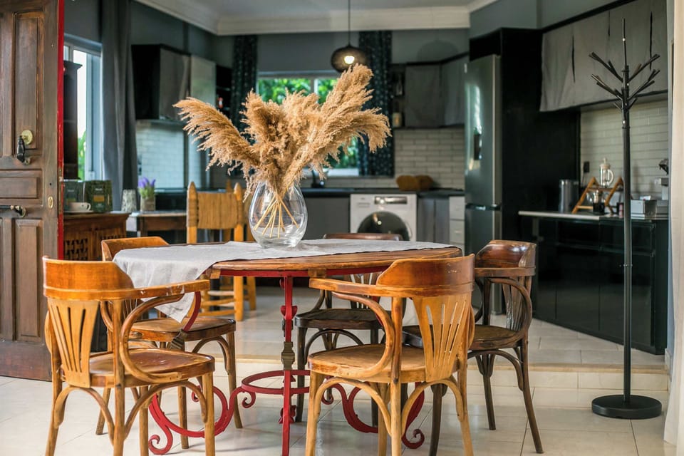 Stylish Dining Space
Enjoy shared meals in this elegant dining area featuring chic wooden chairs, warm lighting, and decorative details that create a welcoming, homey atmosphere