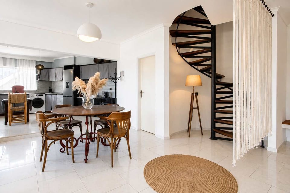 Dining Area next to Spiral Staircase
Stylish dining space beside the statement red staircase, combining comfort and design, a great place to enjoy breakfast before a day by the sea