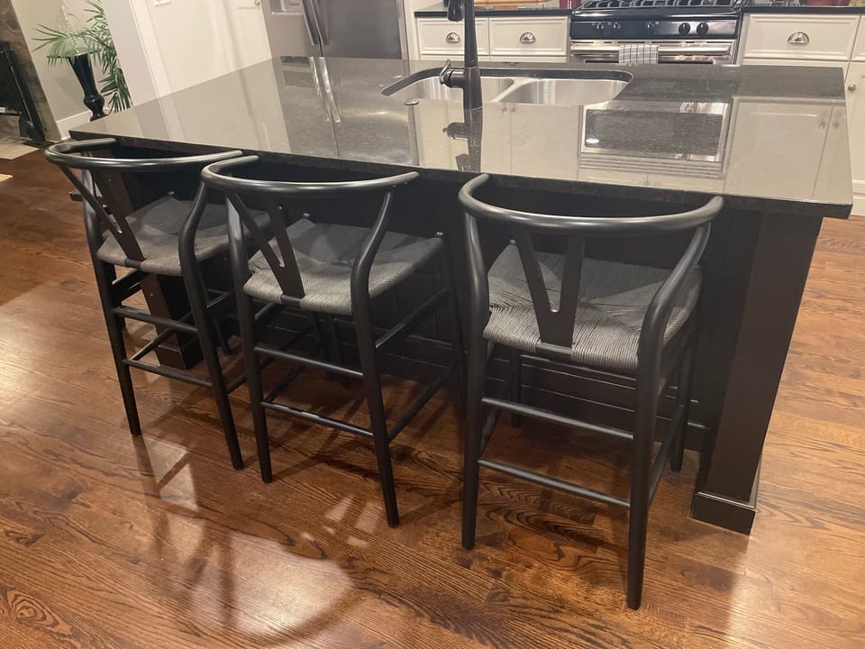 Kitchen island with three stools and a  fourth to the side