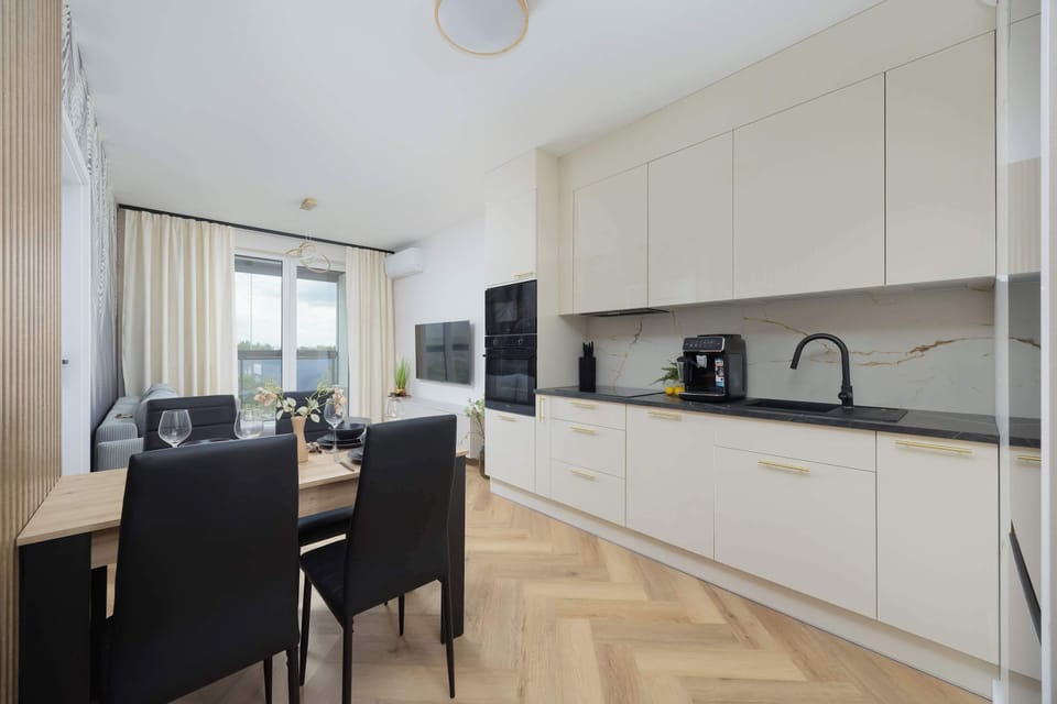 The sleek design of the kitchenette blending seamlessly with the living area.