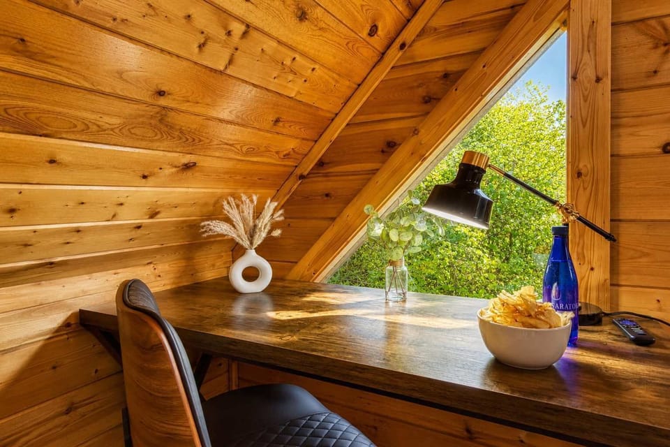Work or study with serene forest views from the dedicated desk, offering peaceful productivity.