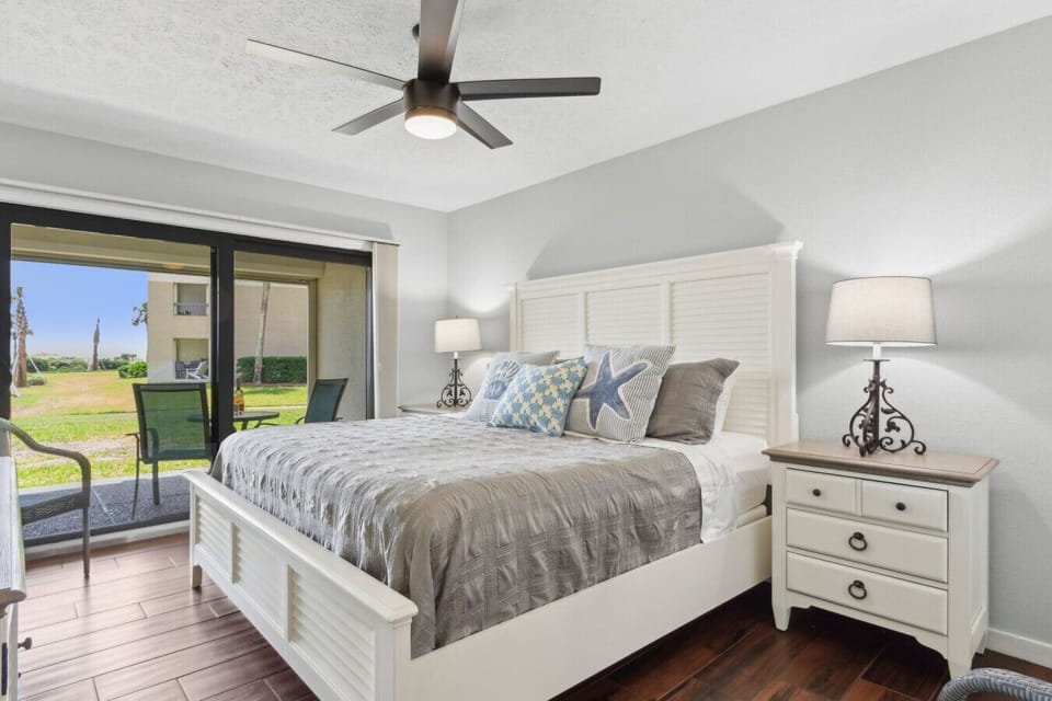King bedroom with sliding glass door to patio