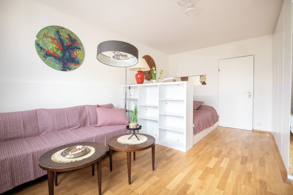 Bright and open bedroom with TV and couch to relax!