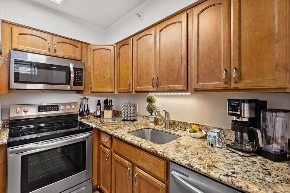 Fully equipped kitchen with stainless steel appliances for easy in-home dining.