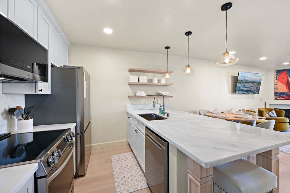 A beautifully renovated kitchen showcasing custom cabinetry and bespoke countertops.
