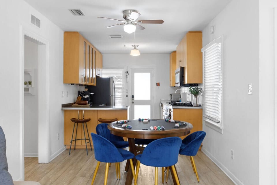 Kitchen and dining area with convertible dining/game table and seating for four