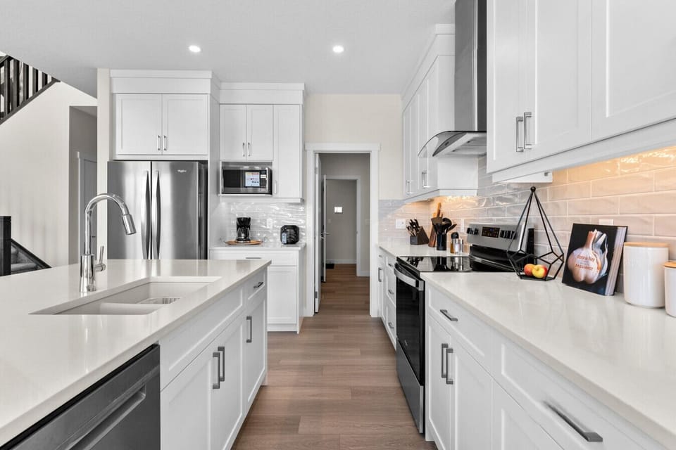 Spacious white kitchen with full appliances and ample counter space