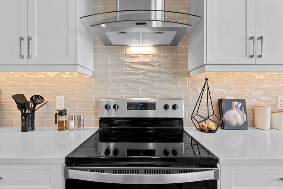 Fully equipped kitchen with electric range and premium hood ventilation