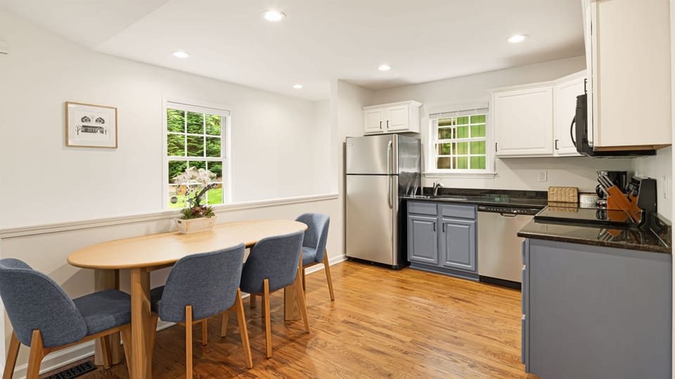 Gather for a meal around the oval dining table — your whole group fits comfortably, and the kitchen is close enough that serving is effortless.