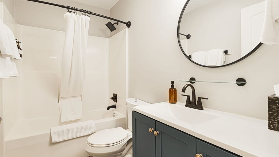Start and end your days in a well-stocked bathroom with a tub/shower combo and a round mirror waiting for you.