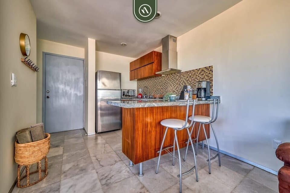 From the stainless steel fridge to the breakfast bar, this kitchen is ready for your culinary creations. Bright, clean, and stocked with everything you need for a stress-free stay.
