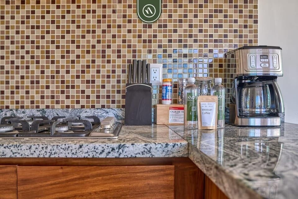 Start your day right with our dedicated coffee station. Featuring a modern drip brewer, quality glassware, and ample counter space for all your morning preparations.