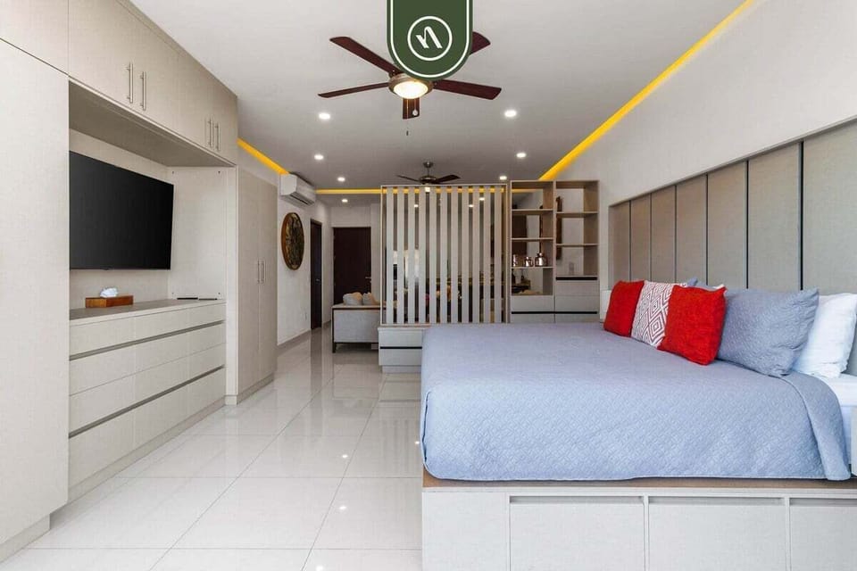Comfortable bedroom layout highlighting ample built-in storage, a flat-screen TV.