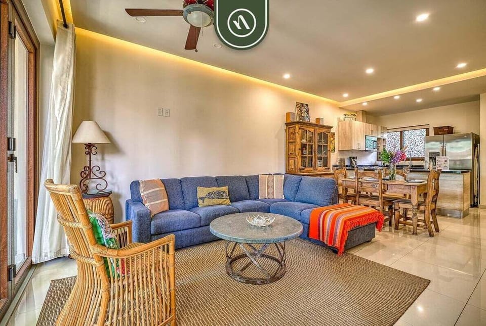 Spacious, open-concept main living area connecting the comfortable lounge space directly to the kitchen and dining room.