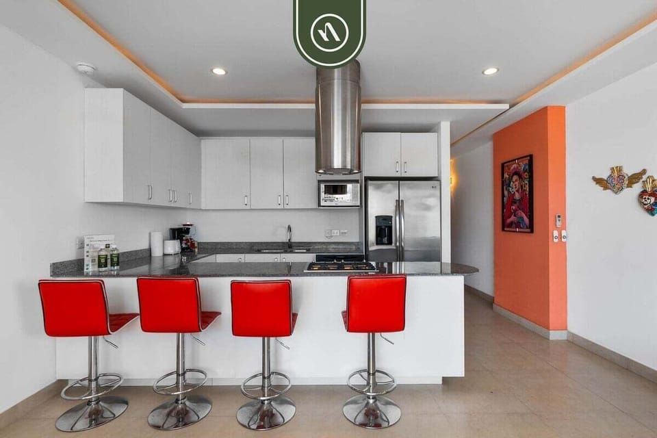 Cook with ease in this spacious, fully equipped kitchen. It boasts stainless steel appliances, ample counter space, and a fun breakfast bar.