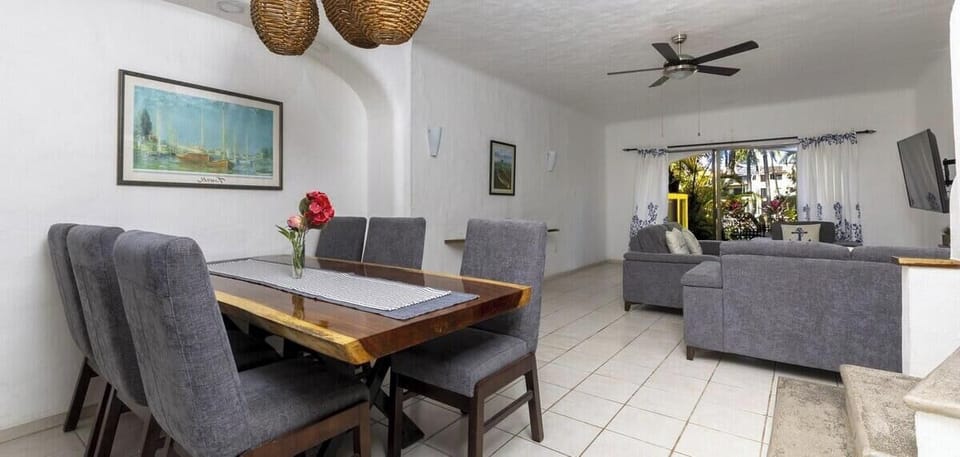 Enjoy the seamless, breezy flow between the dining and living areas. The open architecture creates an inviting atmosphere perfect for socializing during your stay.