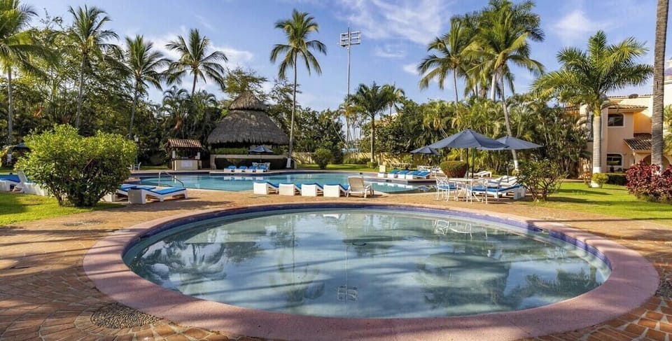 Soak up the sun in our expansive resort-style pool. Relax under the authentic palapa, lounge on the deck, and enjoy the perfect sunny day in this lush green paradise.