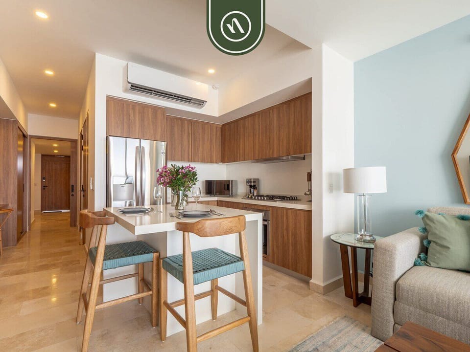 Four-person wooden dining set seamlessly connecting the living area and the kitchen.