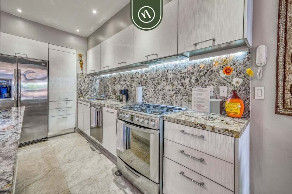 A sleek and fully equipped kitchen designed for both functionality and style, perfect for preparing meals with ease.