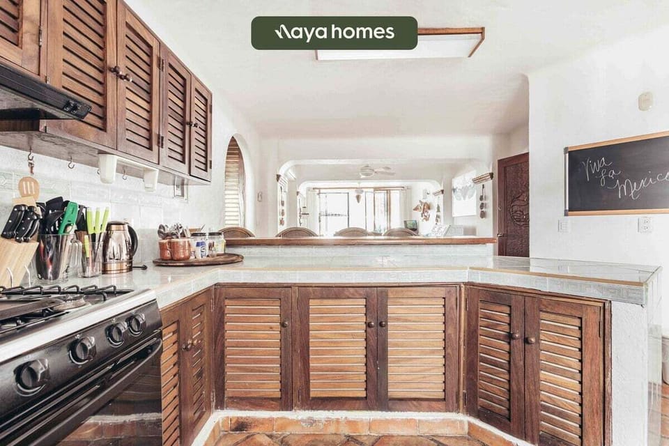 A wide perspective of the kitchen layout highlighting the classic wooden cabinetry and its seamless flow into the main living spaces.