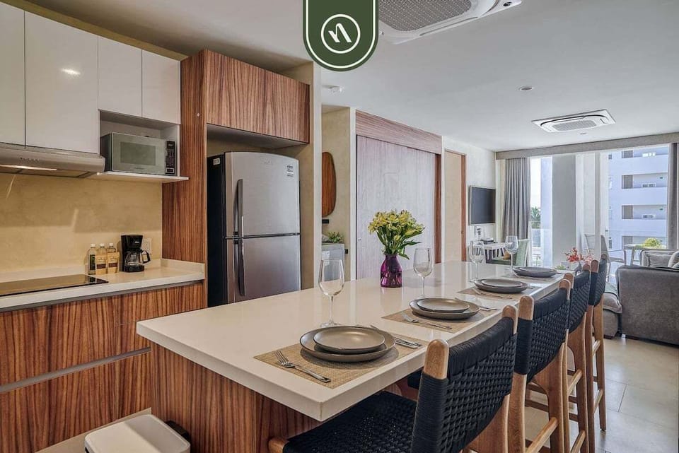 Fully equipped kitchen with sleek finishes, spacious island seating, and everything needed to prepare meals at home.